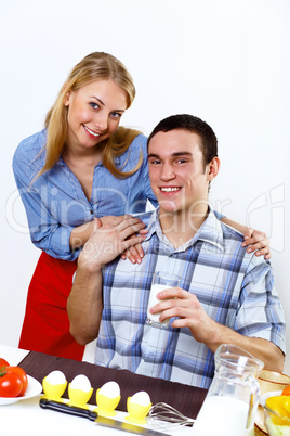 Husband and wife together coooking at home