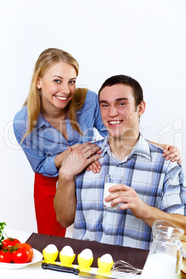 Husband and wife together coooking at home