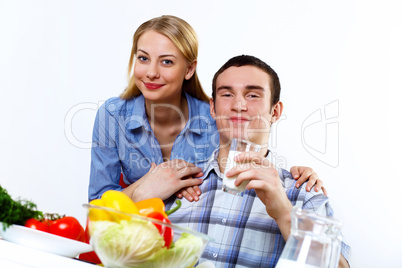 Husband and wife together coooking at home