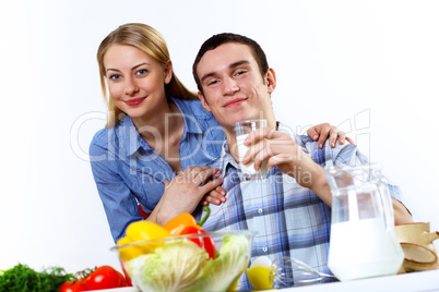 Husband and wife together coooking at home