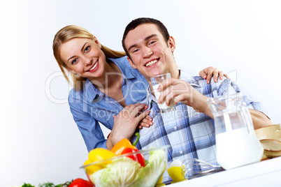 Husband and wife together coooking at home