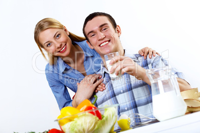 Husband and wife together coooking at home