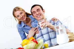 Husband and wife together coooking at home