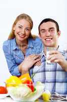 Husband and wife together coooking at home