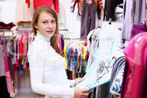 Young woman inside a store buying clothes