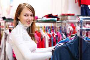 Young woman inside a store buying clothes