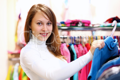 Young woman inside a store buying clothes