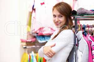 Young woman inside a store buying clothes