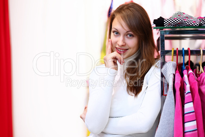 Young woman inside a store buying clothes