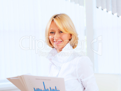 Young beautiful woman in business wear at work