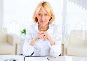 Young beautiful woman in business wear at work