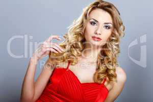 Young woman in red dress with curly hair