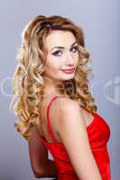 Young woman in red dress with curly hair