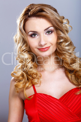 Young woman in red dress with curly hair