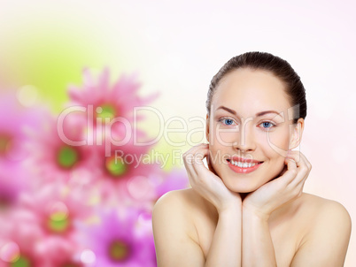 Young woman with flowers on background