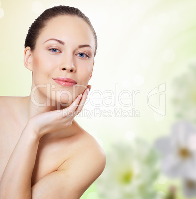 Young woman with flowers on background