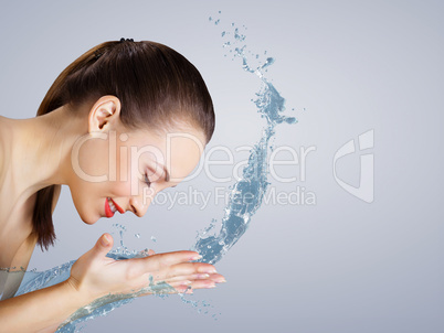 Young woman with water splashes