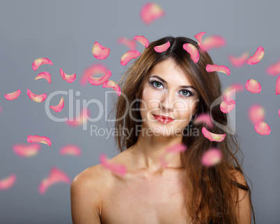 Young woman with flowers on background