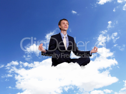 Young businessman sitting and praying