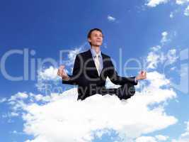 Young businessman sitting and praying