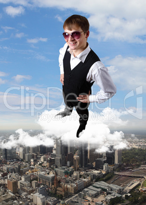 Young businessman against city background