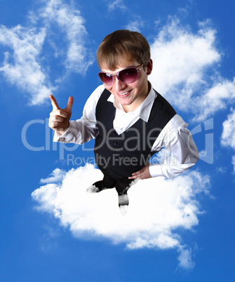 Young businessman against cloudy sky background