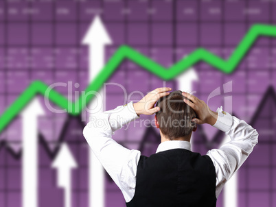 Young businessman against financial graphs