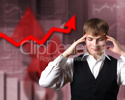 Young businessman against financial graphs