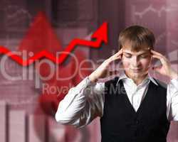 Young businessman against financial graphs