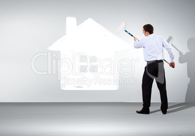 Businessman and picture of house on the wall