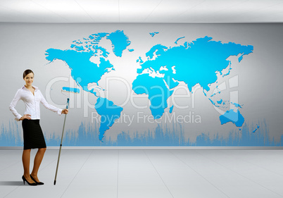 Businesswoman with paint brush and world map