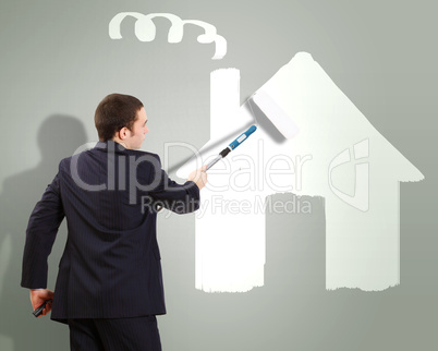 Businessman and picture of house on the wall