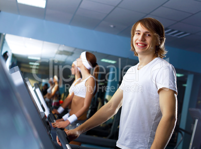 Young man doing sport in gym