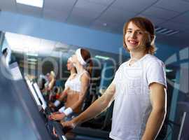 Young man doing sport in gym