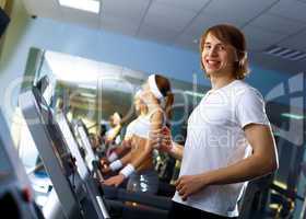 Young man doing sport in gym