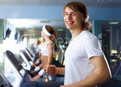 Young man doing sport in gym