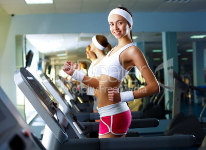 Young woman doing sport in gym Young woman doing sport in gym
