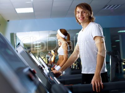 Young man doing sport in gym