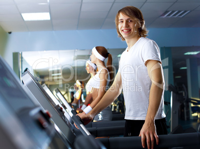 Young man doing sport in gym