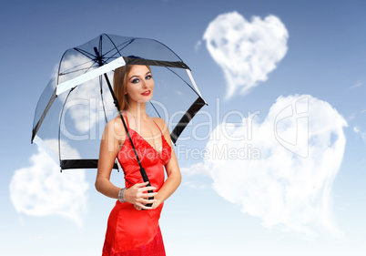 Pretty young woman with umbrella and hearts