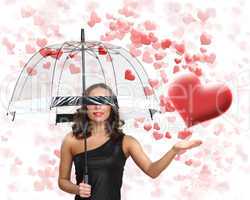 Pretty young woman with umbrella and hearts