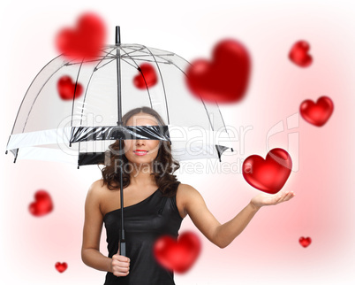 Pretty young woman with umbrella and hearts