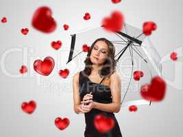 Pretty young woman with umbrella and hearts