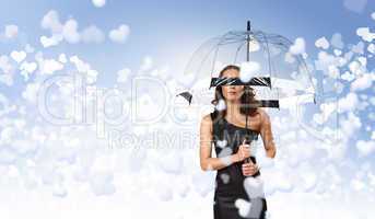 Pretty young woman with umbrella and hearts