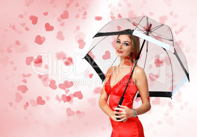 Pretty young woman with umbrella and hearts