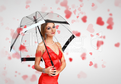 Pretty young woman with umbrella and hearts