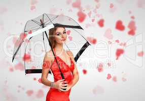 Pretty young woman with umbrella and hearts