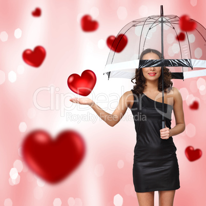 Pretty young woman with umbrella and hearts