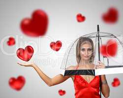 Pretty young woman with umbrella and hearts