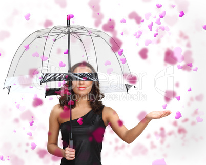 Pretty young woman with umbrella and hearts